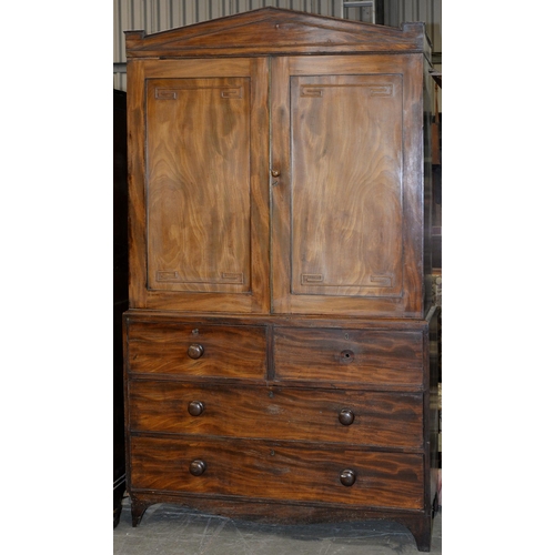 1335 - A George IV mahogany linen press, the triangular pediment above pair of panelled doors with brass be... 