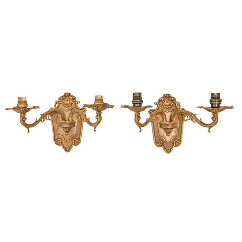 1157 - A pair of gilt lacquered brass twin light wall sconces, mid 20th c, in regence style with cartouche ... 