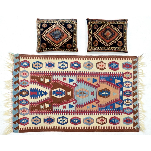 1162 - A flatweave rug and a pair of carpet cushions
