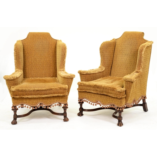 1192 - A substantial pair of William III style wingback armchairs, c1930,  on walnut legs with braganza fee... 