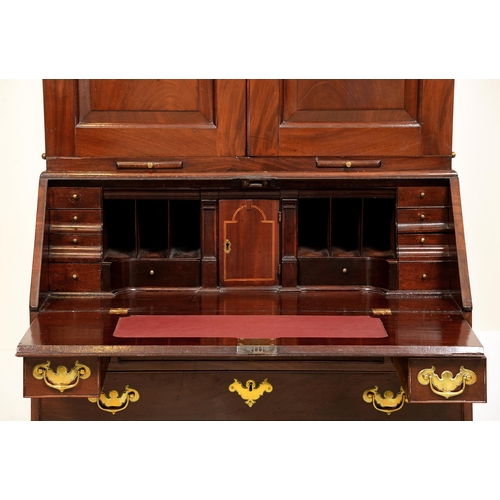 1239 - A George II walnut bureau bookcase, the segmental cornice above arched doors with raised and fielded... 