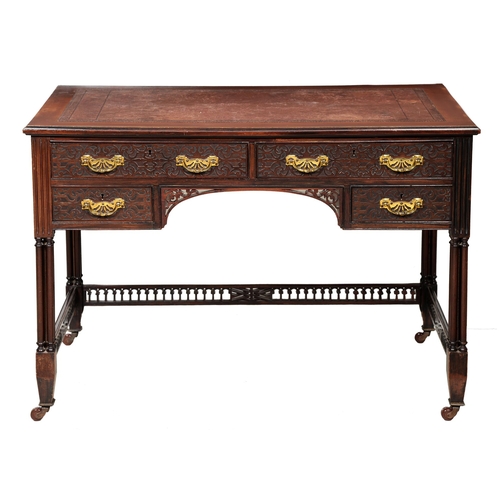 1250 - An Edwardian mahogany writing table, with leather inlaid top, blind fret doors, and fretted apron, o... 