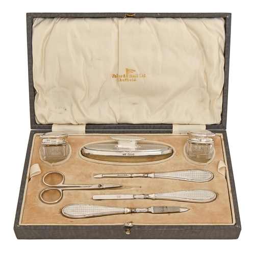 283 - A George V silver manicure set, by Walker & Hall, Sheffield 1929 and circa, cased... 