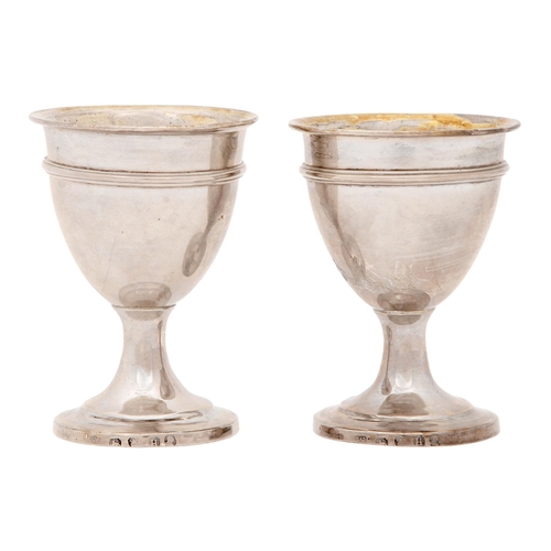 295 - A pair of George III silver eggcups, with reeded girdle, 69mm h, maker's mark rubbed, probably Willi... 