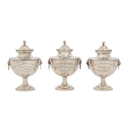 322 - Three George V silver trophy cups and covers, with lion mask and ring handles, engraved inscriptions... 