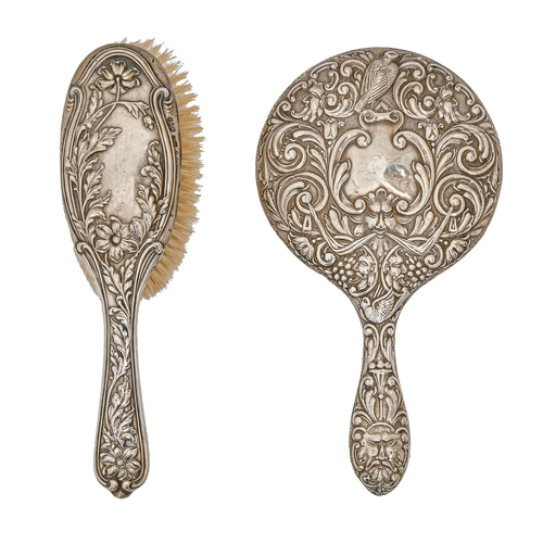 345 - A George V silver hand mirror, stamped with grotesques and birds, by W J Myatt & Co, Birmingham ... 