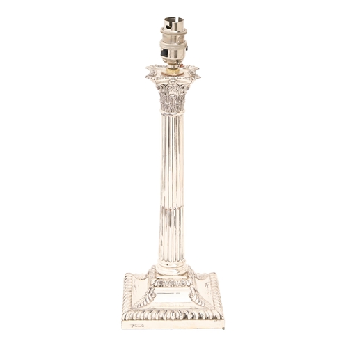 349 - An Edwardian silver column candlestick, the stop fluted shaft on flared square foot with acanthus le... 