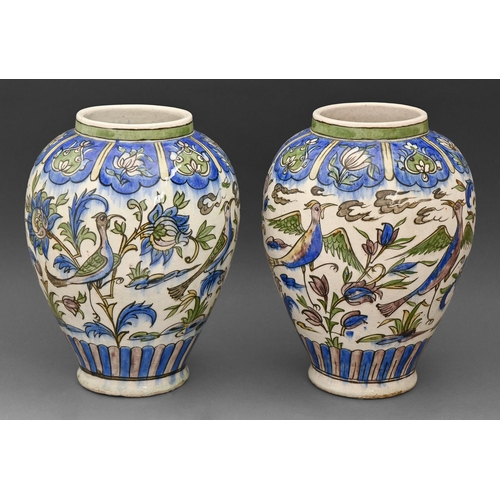 400 - A pair of Persian pottery vases, 19th / early 20th c, painted with birds and flowering plants betwee... 