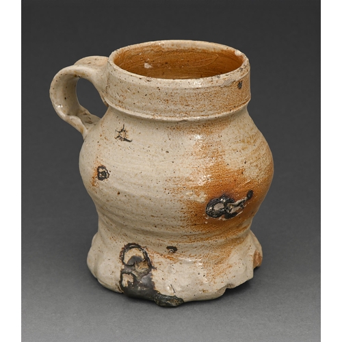 409 - A German stoneware mug, probably Siegburg, early 16th c, loop handle, 10cm h