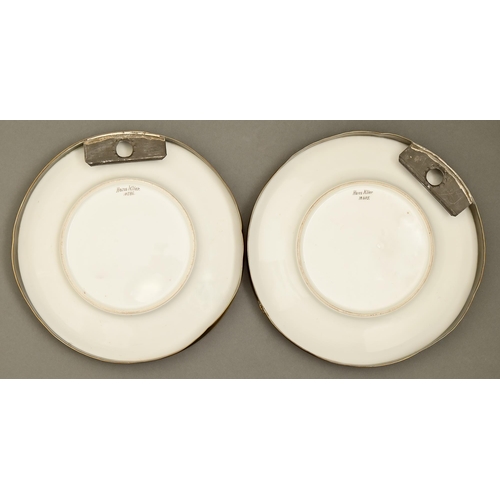 435 - A pair of Continental porcelain plates, outside-decorated, 1885 and 1886, painted in brown monochrom... 