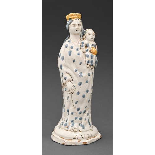 448 - A French faience figure of the Virgin Mary with the Christ Child, early 19th c, decorated principall... 