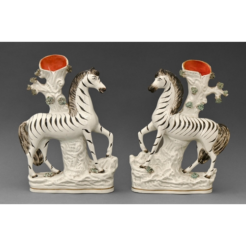 453 - A pair of Staffordshire earthenware prancing zebra flatback spill holders, mid 19th c, 27cm h... 