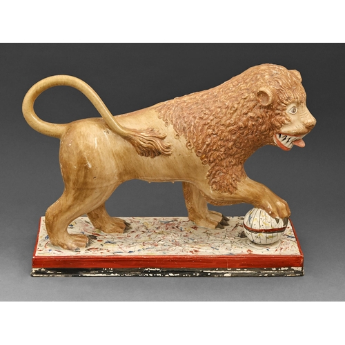 459 - A Staffordshire pearlware model of a lion, early 19th c, painted in overglaze enamels, on marbled ba... 