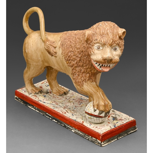 459 - A Staffordshire pearlware model of a lion, early 19th c, painted in overglaze enamels, on marbled ba... 