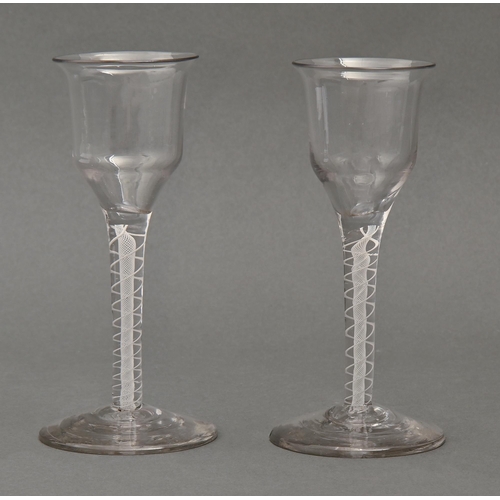 472 - A pair of wine glasses, 19th c,  the ogee bowl with flared lip, on double series opaque twist stem, ... 