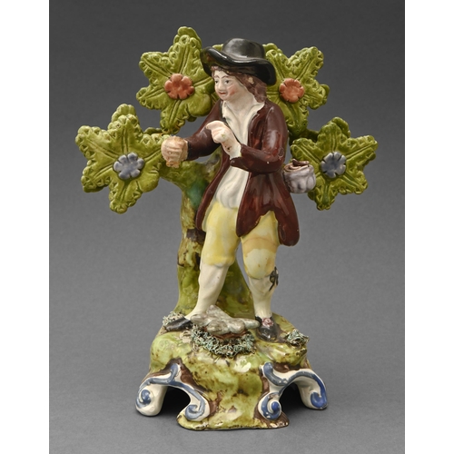 484 - A Staffordshire pearlware figure of a boy, early 19th c, brightly painted in overglaze enamels, 17cm... 