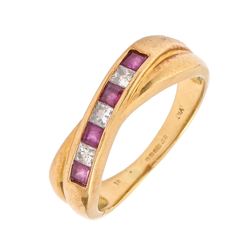 56 - A ruby and diamond crossover ring, with calibre cut rubies and princess cut diamonds, in 18ct gold, ... 