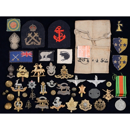 566 - Miscellaneous British military cap badges and cloth insignia, including UK 37th Searchlight Regiment... 