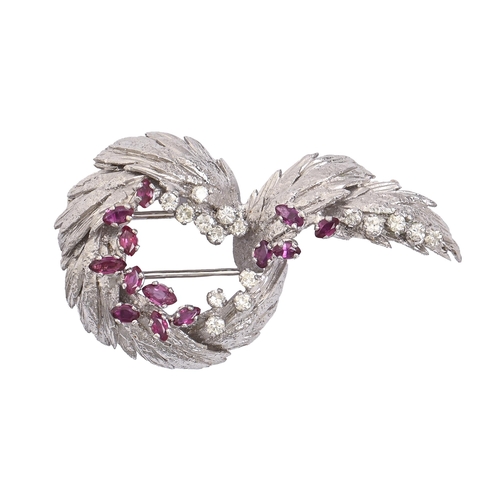 60 - A ruby and diamond brooch, of leafy entwined design, with melee of even round brilliant cut diamonds... 