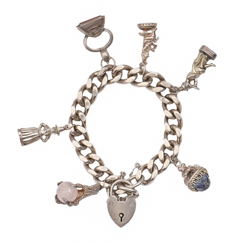 72 - A silver charm bracelet, hung with a collection of silver charms and a 19th c seal, approximately 20... 
