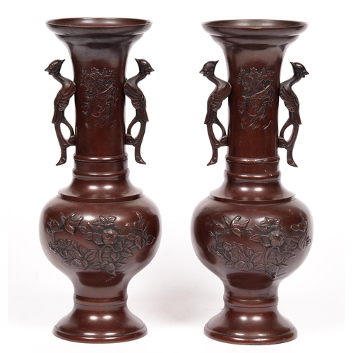 754 - A pair of Japanese bronze twin-handled vases, Meiji period, with flared neck, decorated with birds a... 