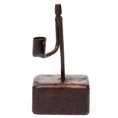 775 - A British iron rush nip and holder, on stained wood block, 18th c, 21cm h