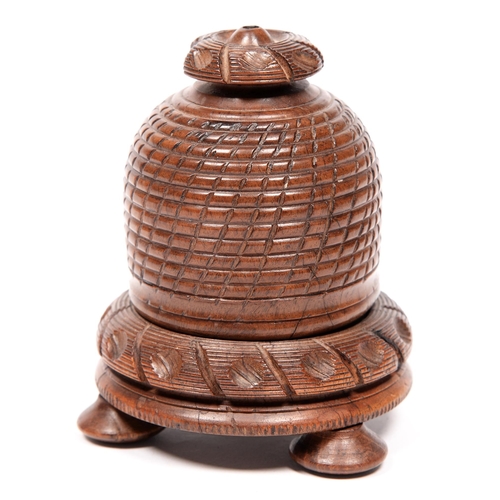 776 - Treen. A Victorian turned walnut bee skep shaped string box and base, on three feet, 12cm h... 