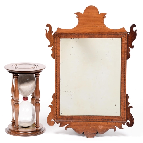 819 - A Victorian walnut fretwork mirror, 43cm h, and a walnut hourglass, 22cm h (2)