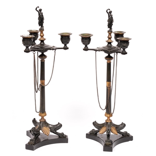 853 - A pair of Napoleon III gilt and patinated bronze candelabra of three lights, on fluted shaft and thr... 