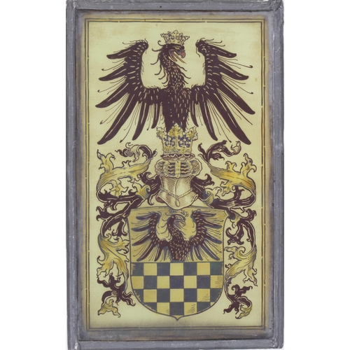 884 - A German historismus stained glass armorial window light, with shield crests, crown helm and mantlin... 