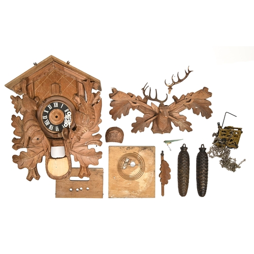 899 - A Swiss carved limewood Black Forest cuckoo clock, with carved stag's head pediment and acorn weight... 