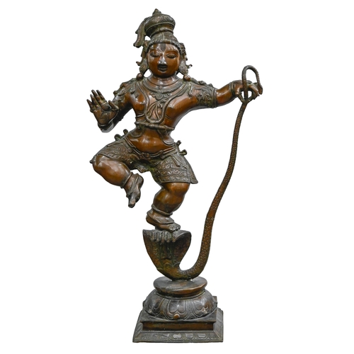 906 - An Indian bronze statue of Krishna dancing on Kaliya, 90cm h