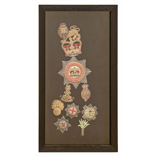 925 - Militaria. Two framed displays of British Guard's regimental cloth and metal thread insignia, 36cm a... 