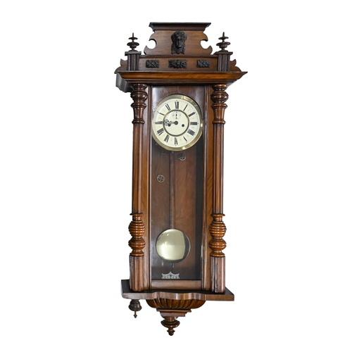 938 - A walnut Vienna wall clock, c.1900, with primrose enamel dial, pendulum, 120cm h