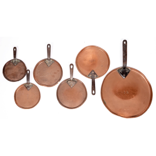 935A - A Victorian copper pan lid with iron handle, stamped I R, 34cm diam, and five contemporary smaller e... 