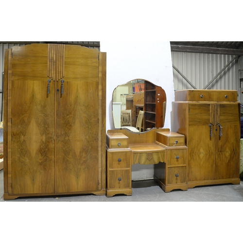 1324 - A walnut three-piece bedroom suite, c 1930, comprising wardrobe, mirror back dressing table and tall... 