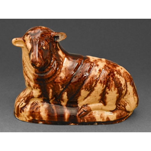 508 - An English earthenware model of a recumbent sheep, early 19th c, covered in a straw coloured and str... 