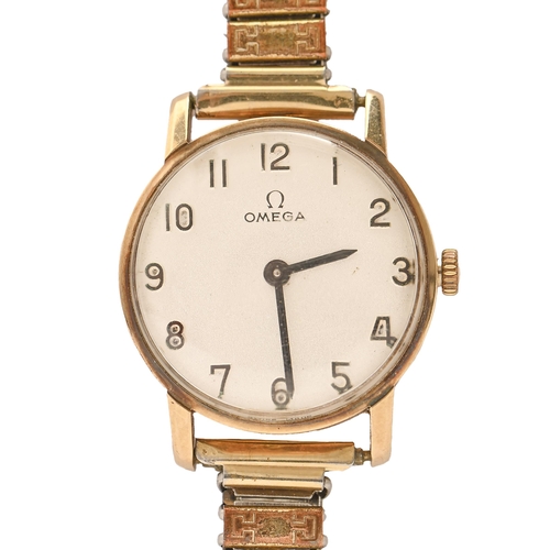 102 - An Omega gold lady's watch,  23mm diam, on associated base metal expanding bracelet... 