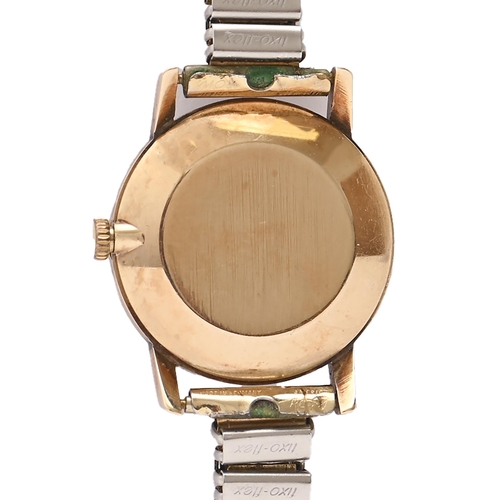 102 - An Omega gold lady's watch,  23mm diam, on associated base metal expanding bracelet... 