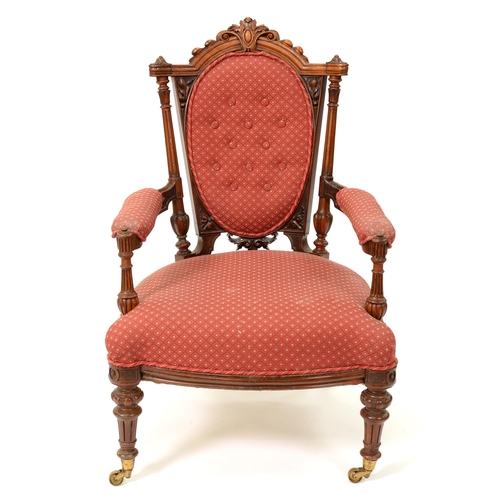 1201 - A Victorian carved walnut open armchair, with curved, added buttoned oval back