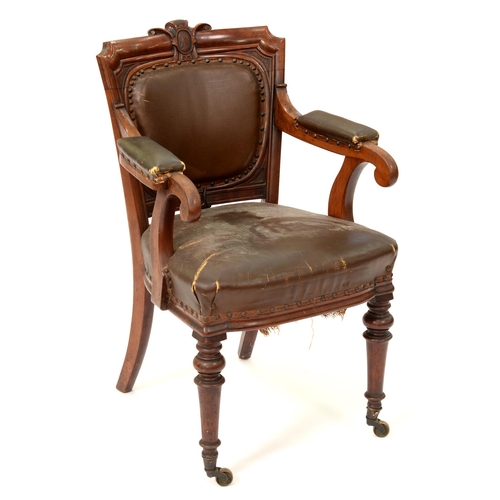 1203 - A Victorian mahogany library chair, with padded back and arms on brass castors, 90cm h... 