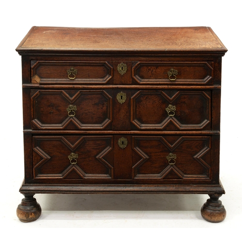 1212 - A William III geometric-moulded oak chest of three drawers, the sides panelled, on bun feet, 77cm h;... 