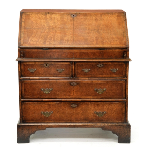 1214 - A walnut and crossbanded bureau, c1930, in Queen Anne style, the stepped, fitted interior with well,... 