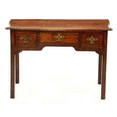 1233 - A George III oak lowboy with serpentine top, 72cm h; 54 x 104cm