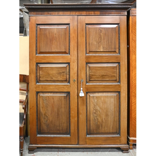 1309 - A Channel Island's mahogany wardrobe, early mid 19th c, with panelled doors, 210cm h; 150cm x 63cm... 