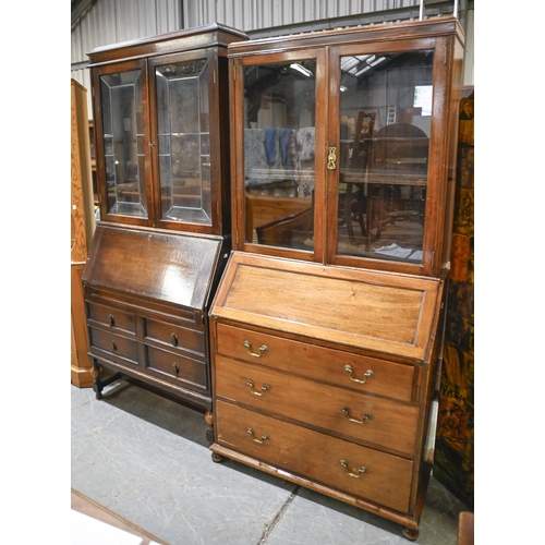 1322 - A mahogany bureau bookcase, early 20th c, the upper part enclosed by glazed doors, on turned bun fee... 