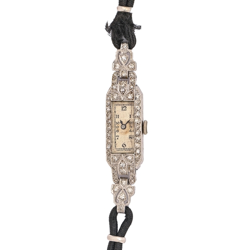 139 - A diamond cocktail watch, c1940, in platinum with articulated lugs, 11mm x 52mm