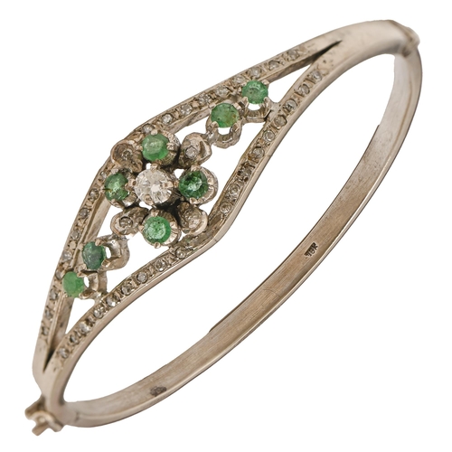 187 - An emerald and diamond bangle, in white gold, 55mm diam, marked 18K, 20.7g