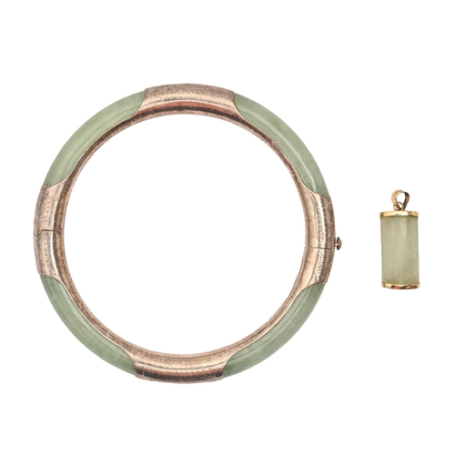 204 - A silver mounted jade bangle, 56mm (internal) and a gold mounted jade pendant 24.6g (2)... 