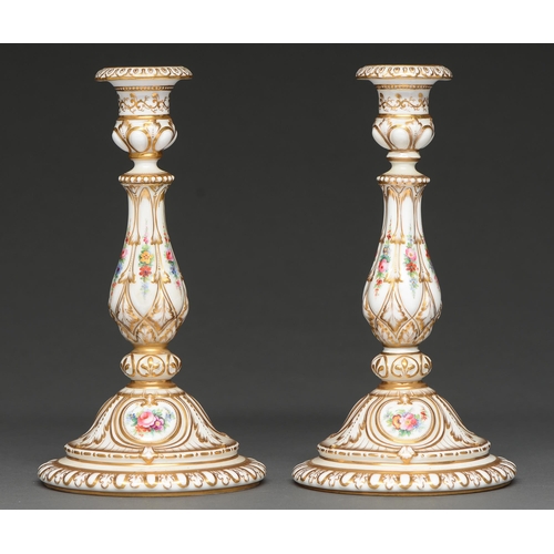 399 - A pair of English porcelain candlesticks, c1850, painted with flowers and richly gilt, 24.5cm h... 